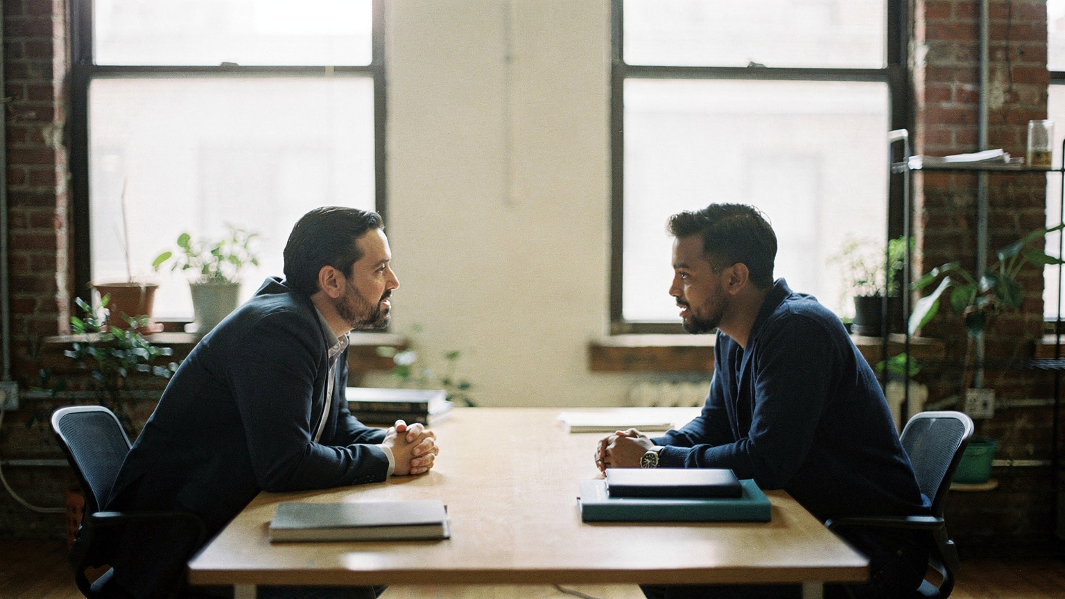 A client and agency lead in conversation about Magento agency accountability in a Brooklyn office