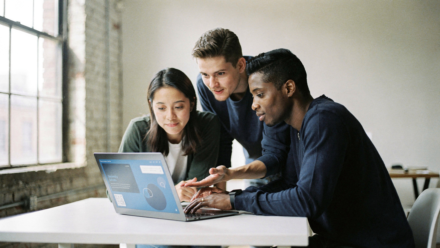 A DTC brand team reviewing a simpler operating setup on a laptop in a minimal Brooklyn studio